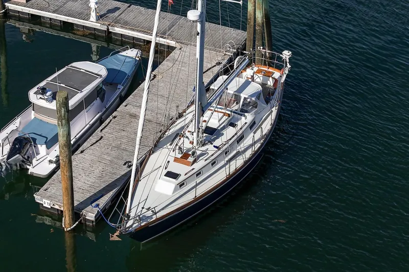 Slide: The Image of Aerial view of 1984 Hank Hinckley OC42 sailboat docked beside a motorboat. - 3