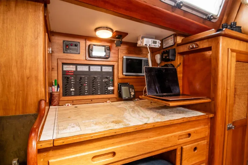 Slide: The Image of Navigation station on 1984 Hank Hinckley OC42 sailboat with map, electronics, and laptop. - 30