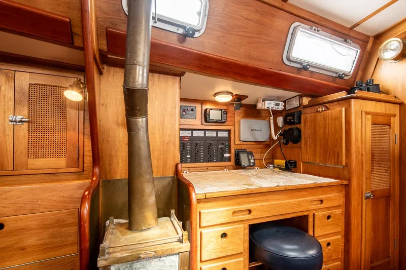 Slide: The Image of 1984 Hank Hinckley OC42 yacht interior with navigation station and wood paneling. - 33