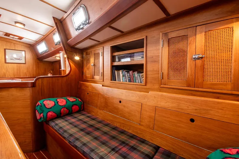 Slide: The Image of Cozy 1984 Hank Hinckley OC42 yacht interior with wooden cabinetry and plaid seating. - 35