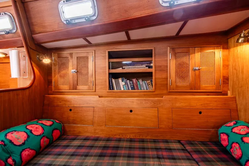 Slide: The Image of Cozy wooden interior of 1984 Hank Hinckley OC42 sailboat with bookshelves and plaid seating. - 36