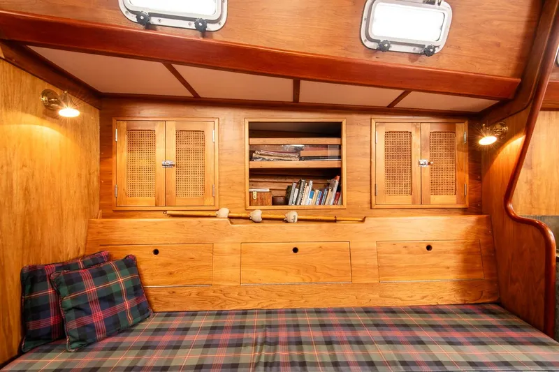 Slide: The Image of Cozy 1984 Hank Hinckley OC42 yacht interior with wooden cabinets and plaid cushions. - 37