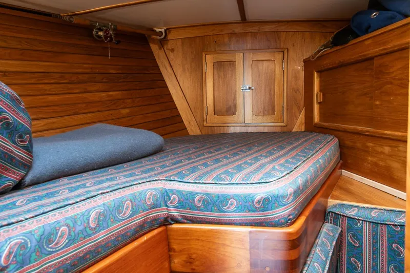 Slide: The Image of Cozy cabin interior of 1984 Hank Hinckley OC42 sailboat with patterned bedding. - 40