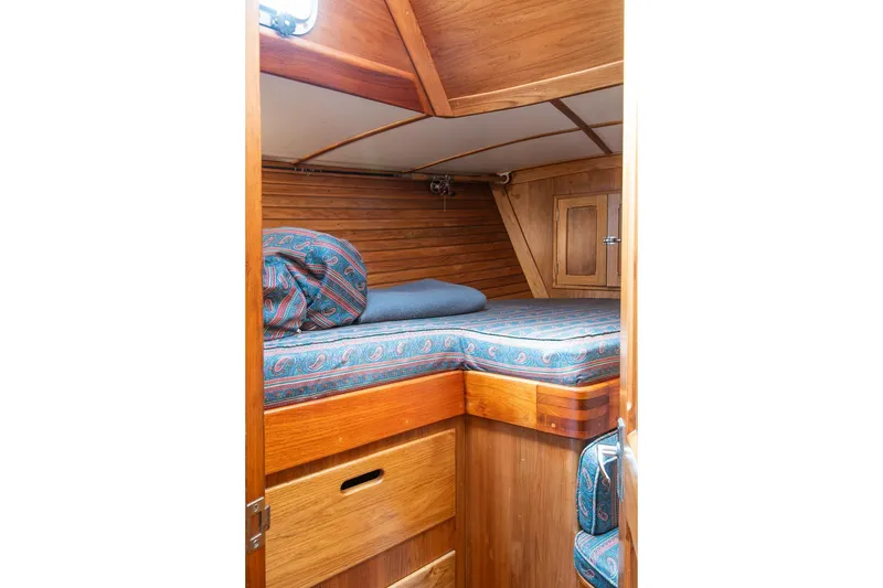 Slide: The Image of Cozy cabin interior of 1984 Hank Hinckley OC42 sailboat with wooden finish and patterned bedding. - 41