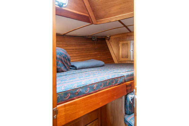 Slide: The Image of Cozy cabin interior of 1984 Hank Hinckley OC42 sailboat with patterned bedding. - 42