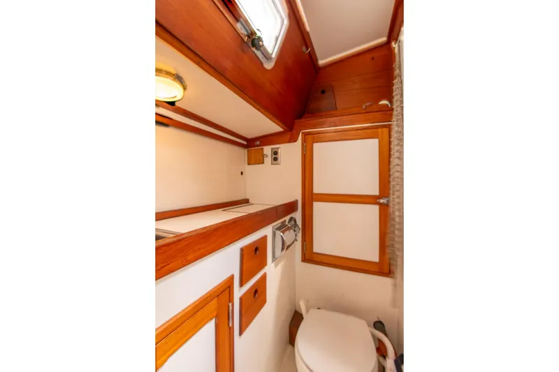 Slide: The Image of 1984 Hank Hinckley OC42 yacht bathroom with wooden cabinetry and compact design. - 53