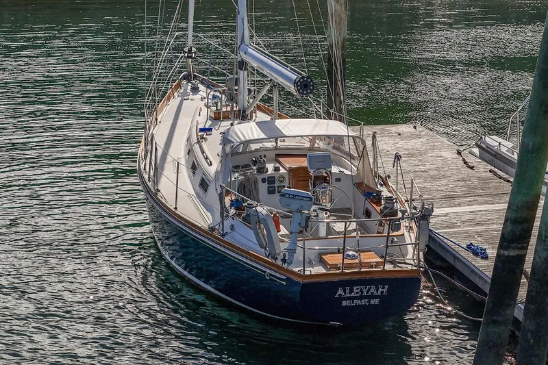 Slide: The Image of Sailboat "Aleyah" docked, Hank Hinckley OC42, 1984 model, in calm waters. - 7