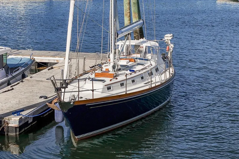 Slide: The Image of Sailboat Hank Hinckley OC42, 1984 model, docked at marina with clear blue water. - 8