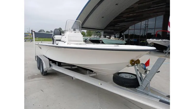 Slide: The Image of 2006 Mako 211 boat on trailer, parked outdoors near a building. - 8