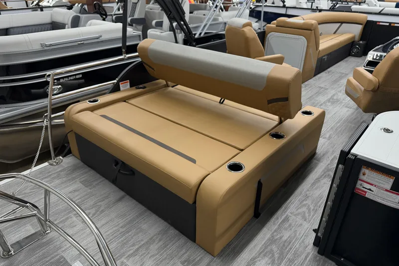 Slide: The Image of 2026 Crest Conquest 235 SLSC boat interior with tan seating and cup holders. - 11