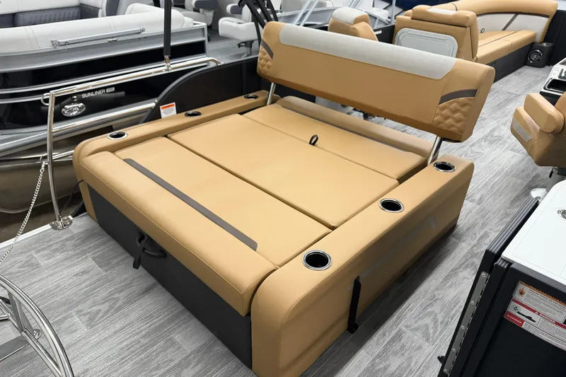 Slide: The Image of 2026 Crest Conquest 235 SLSC boat interior with tan seating and cup holders. - 12