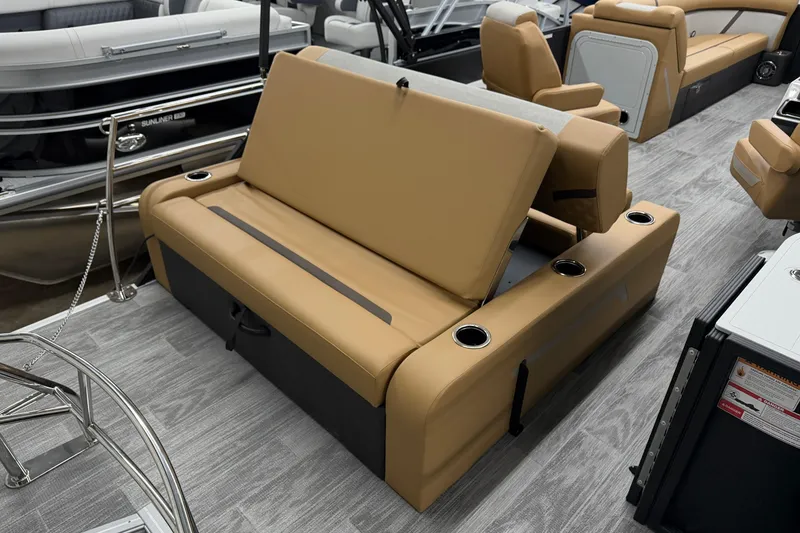 Slide: The Image of 2026 Crest Conquest 235 SLSC boat interior with tan seating and cup holders. - 13