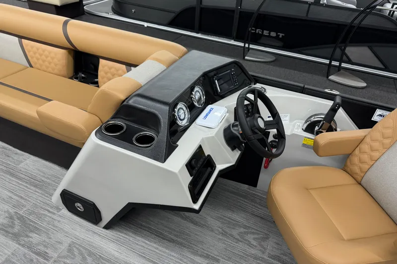 Slide: The Image of Interior of 2026 Crest Conquest 235 SLSC boat with tan seating and modern dashboard. - 5