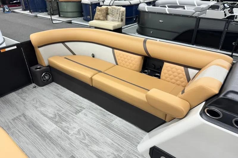 Slide: The Image of Luxurious seating on 2026 Crest Conquest 235 SLSC pontoon boat, featuring tan upholstery and modern design. - 9