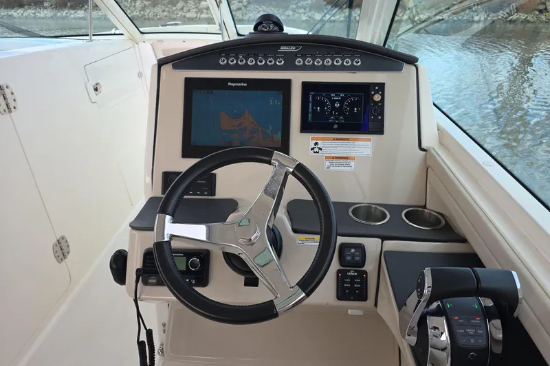Slide: The Image of 2018 Boston Whaler 320 Vantage helm with navigation screens and controls. - 11