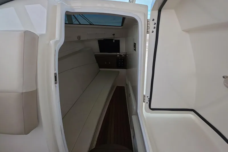 Slide: The Image of Interior cabin of 2018 Boston Whaler 320 Vantage boat, featuring seating and storage. - 13