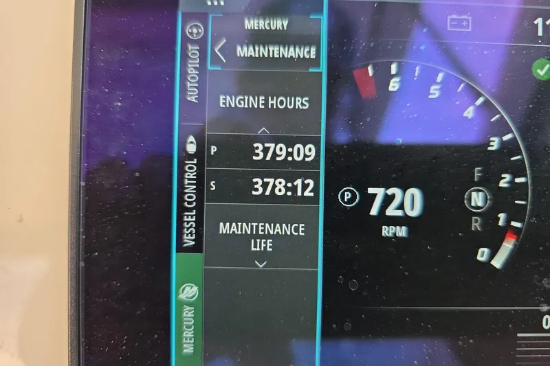 Slide: The Image of Display screen of a 2018 Boston Whaler 320 Vantage showing engine hours and RPM. - 18