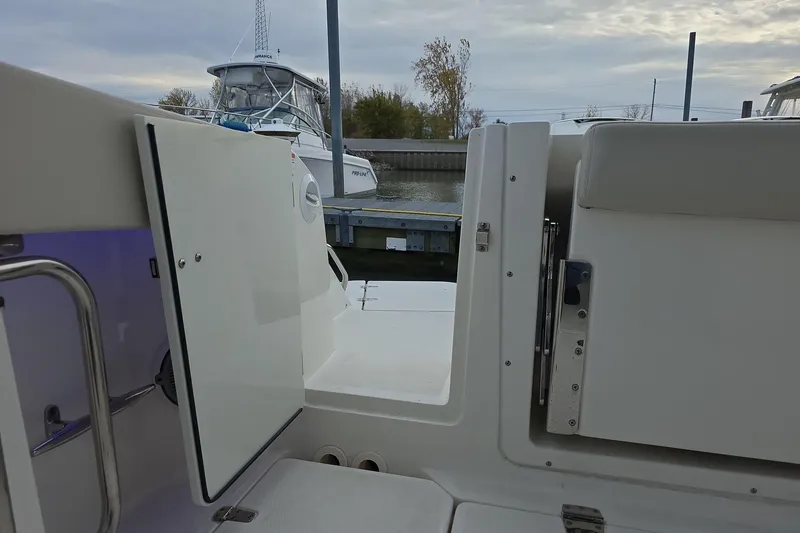 Slide: The Image of 2018 Boston Whaler 320 Vantage boat interior with open door, docked at marina. - 19