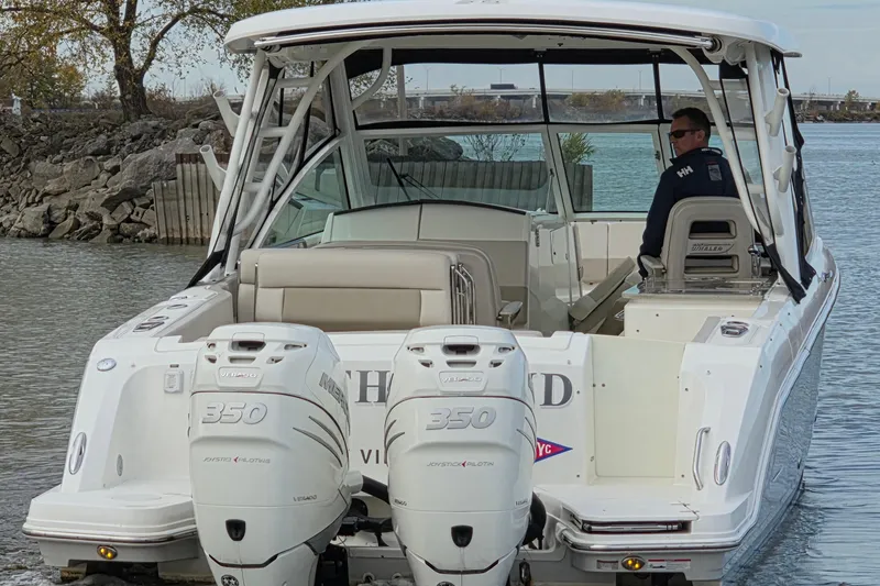 Slide: The Image of 2018 Boston Whaler 320 Vantage boat with twin Mercury 350 engines on water. - 2