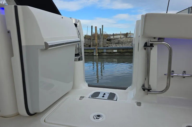 Slide: The Image of Boston Whaler 320 Vantage 2018 boat deck with open door, dockside view. - 20