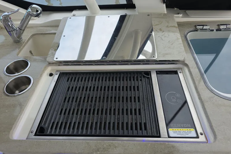 Slide: The Image of Boston Whaler 320 Vantage 2018 boat grill and sink setup with Kenyon grill. - 22