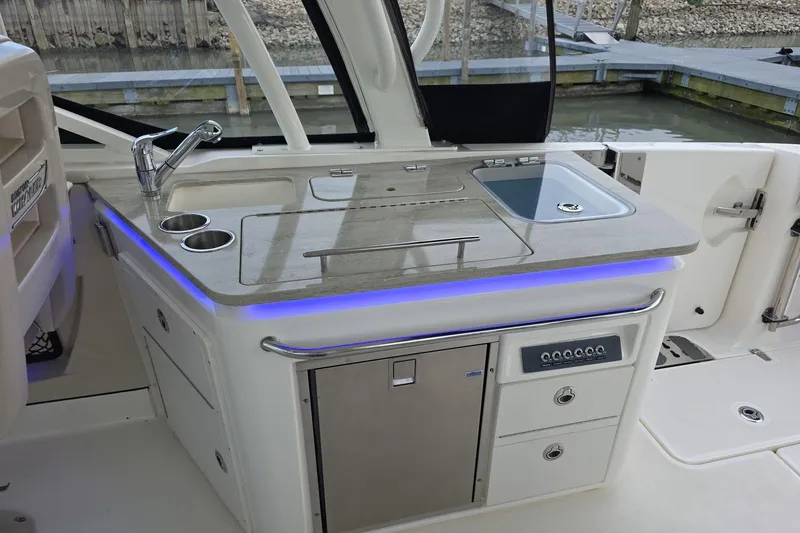 Slide: The Image of 2018 Boston Whaler 320 Vantage boat kitchen with sink, storage, and modern design. - 23