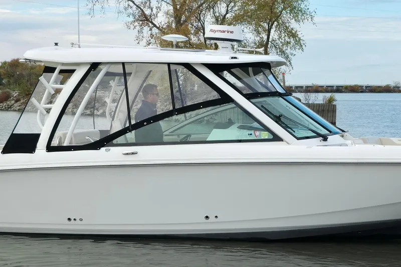 Slide: The Image of 2018 Boston Whaler 320 Vantage boat cruising on a calm waterway. - 6