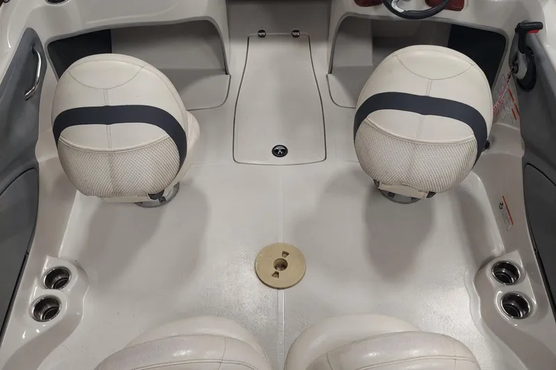 Slide: The Image of Interior of a 2013 Nitro 290 Sport boat featuring two white seats and a clean deck. - 11