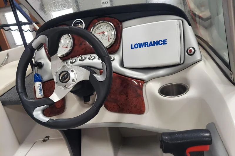 Slide: The Image of 2013 Nitro 290 Sport boat dashboard with steering wheel and Lowrance display. - 12