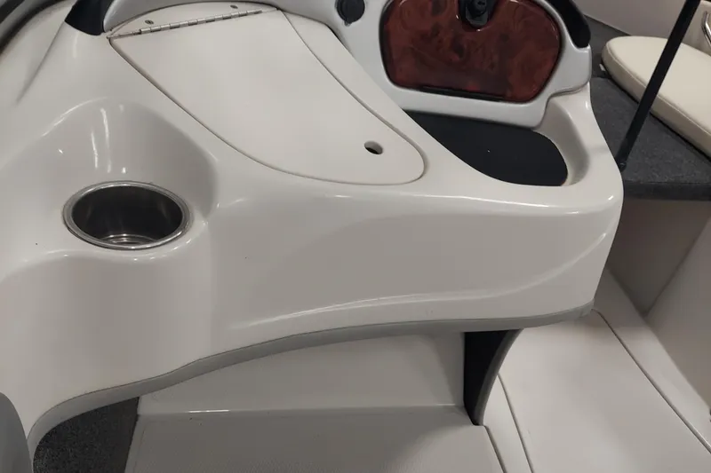 Slide: The Image of Interior of a 2013 Nitro 290 Sport boat featuring a cup holder and storage compartment. - 13