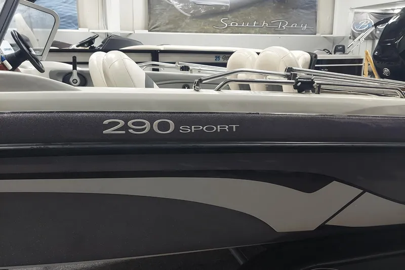 Slide: The Image of 2013 Nitro 290 Sport boat interior with white seating and steering wheel. - 2