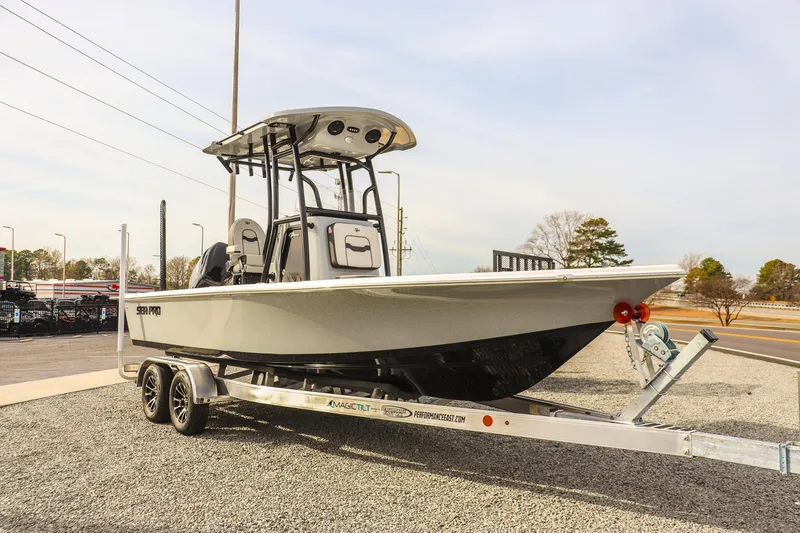 The Image of 2026 Sea Pro 230 Bay boat on trailer, parked outdoors on gravel. - 0