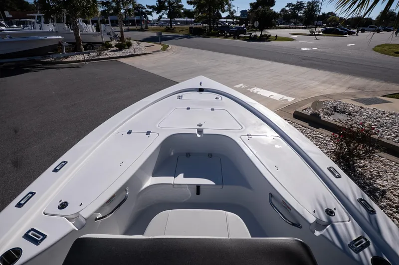 Slide: The Image of 2026 Sea Pro 230 Bay boat seat with logo, cup holder, and engine in background. - 17