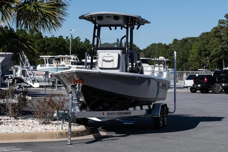 Slide: The Image of 2026 Sea Pro 230 Bay boat with powerful outboard motor, parked on gravel. - 3