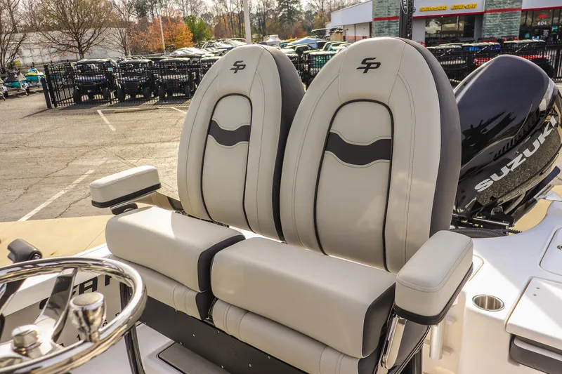 Slide: The Image of 2026 Sea Pro 230 Bay boat seats with Suzuki engine in a dealership lot. - 31