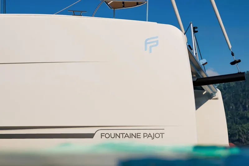 Slide: The Image of 2026 Fountaine Pajot 48 yacht, sleek design, partial view, blue sky background. - 31