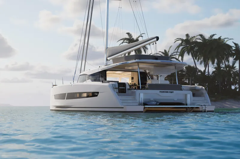 Slide: The Image of 2026 Fountaine Pajot 48 catamaran sailing near tropical island with palm trees. - 36