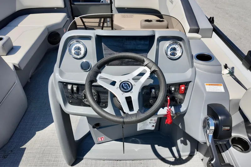 Slide: The Image of 2026 Sylvan A16 LZ boat dashboard with steering wheel and control panel. - 3