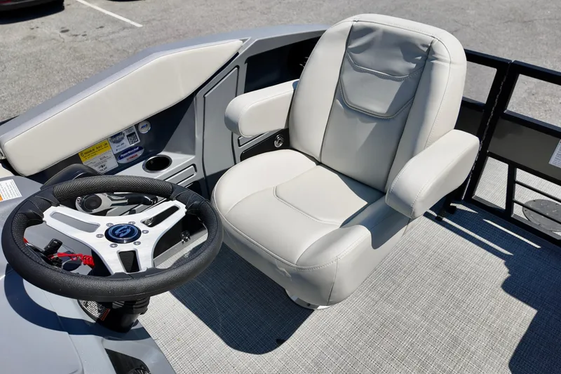 Slide: The Image of Captain's chair and steering wheel of 2026 Sylvan A16 LZ boat, showcasing modern design. - 4