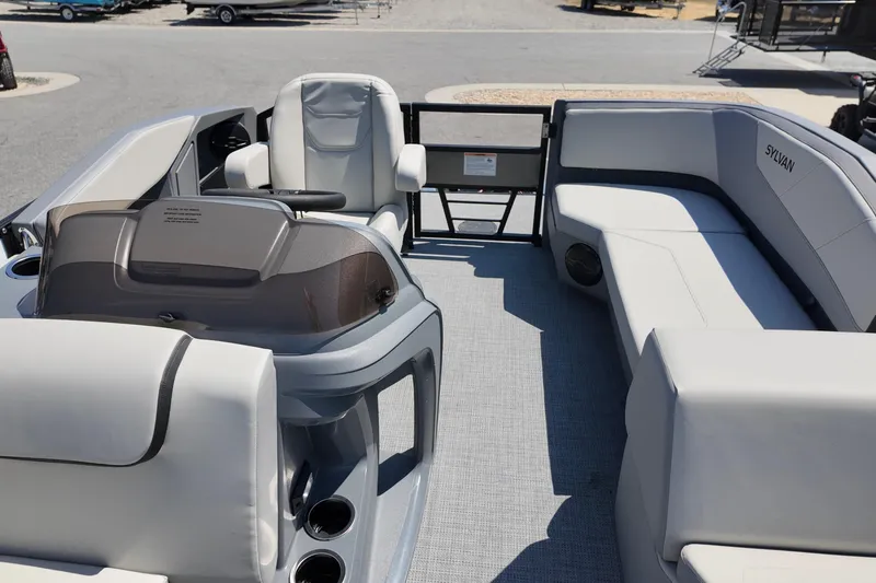 Slide: The Image of 2026 Sylvan A16 LZ boat interior with modern seating and steering console. - 7