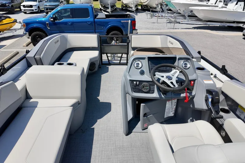 Slide: The Image of Interior view of 2026 Sylvan A16 LZ boat with modern steering console and seating. - 9