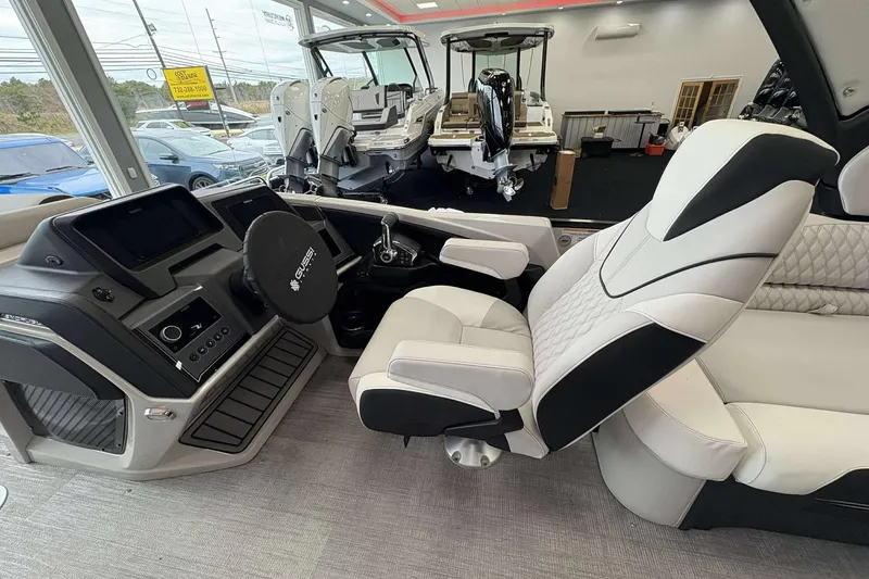 Slide: The Image of Luxurious interior of 2026 Avalon Excalibur 25' boat with modern helm and seating. - 10