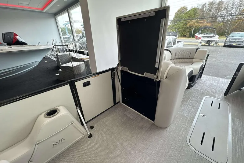Slide: The Image of Interior of 2026 Avalon Excalibur 25' boat with open storage compartment and seating. - 17