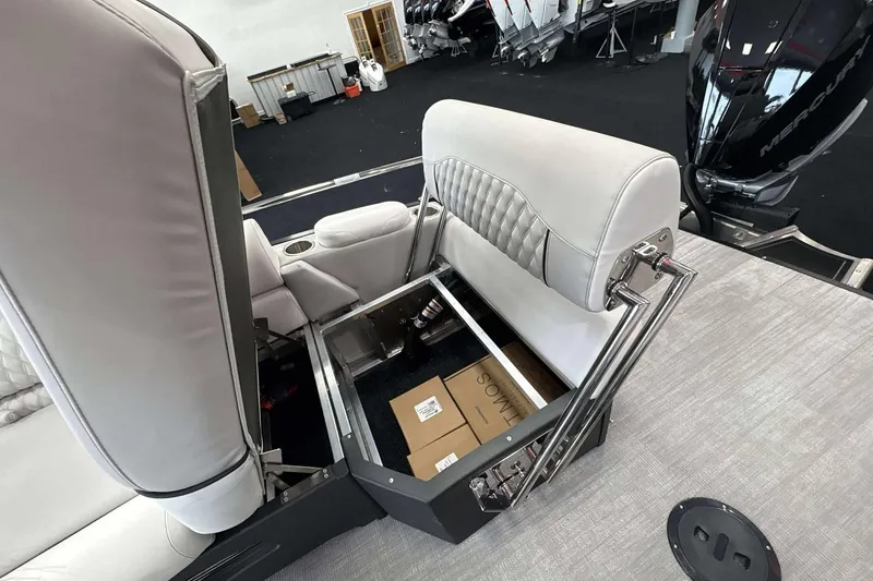 Slide: The Image of 2026 Avalon Excalibur 25' boat interior with open storage under plush seating. - 25