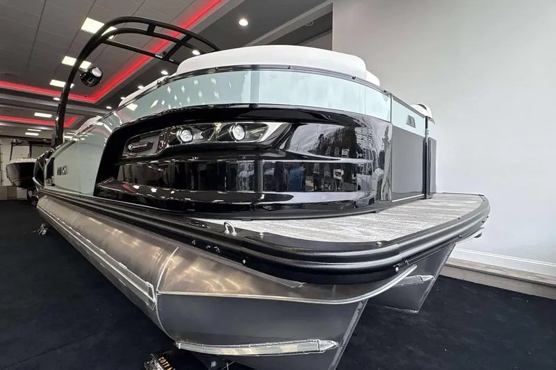 Slide: The Image of 2026 Avalon Excalibur 25' pontoon boat in showroom, sleek design with modern features. - 28