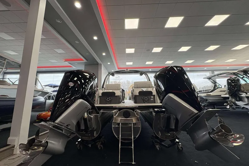 Slide: The Image of 2026 Avalon Excalibur 25' boat with dual engines in a showroom setting. - 5