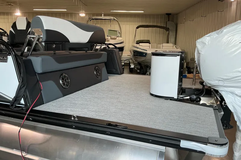 Slide: The Image of 2026 Avalon LSZ CRB pontoon boat interior with seating and storage in a showroom. - 4