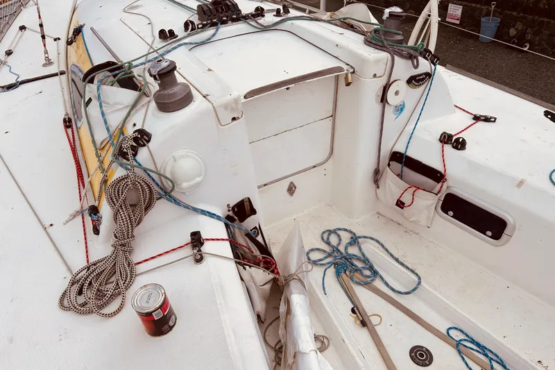 Slide: The Image of 2003 Beneteau Figaro 2 sailboat deck with ropes and winches. - 11