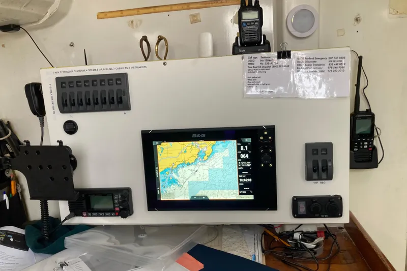 Slide: The Image of Control panel of a 2003 Beneteau Figaro 2 with navigation equipment and communication devices. - 18