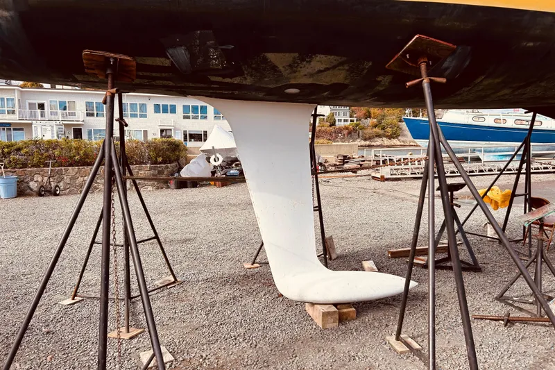 Slide: The Image of Keel of 2003 Beneteau Figaro 2 sailboat on stands in a boatyard. - 24